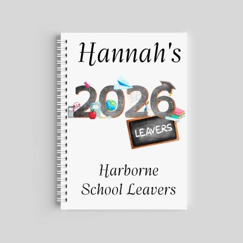 A spiral-bound A5 notebook with a white cover. It features the name "Hannah" at the top, a large "2026" graphic decorated with school supplies and a "Leavers" chalkboard, and "Harborne Primary School" printed at the bottom.