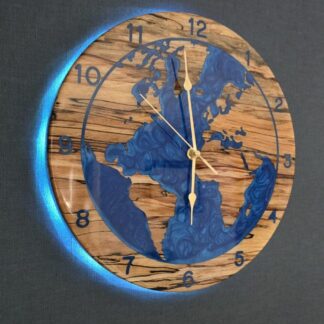 Spalted beech world map wall clock with deep blue resin oceans and integrated LED halo backlight, 315mm handmade wooden clock by The Humble Woodshed.