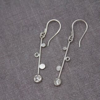 sterling silver drop earring long bar detailed with disc, tiny ring and starburst on hook back