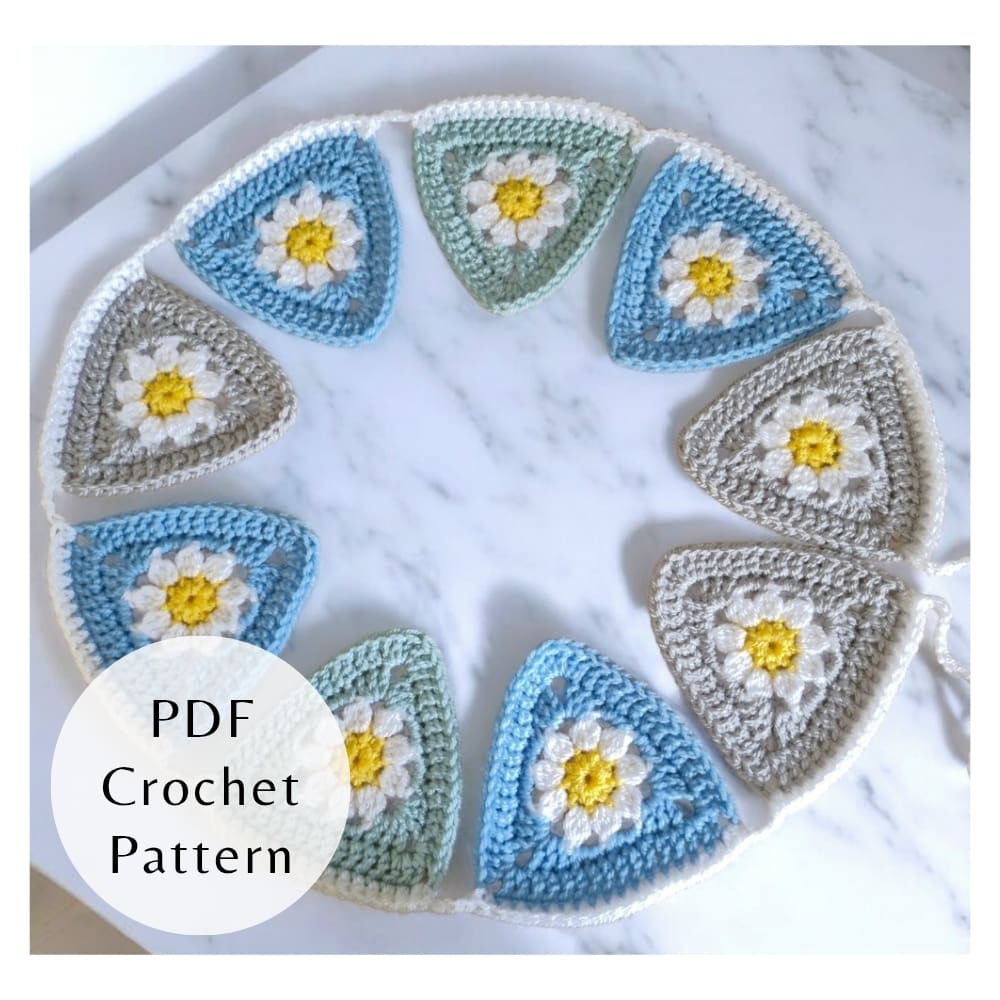 A colourful crochet daisy bunting garland with textured flower centres and granny triangle edges, shown as a PDF pattern guide.