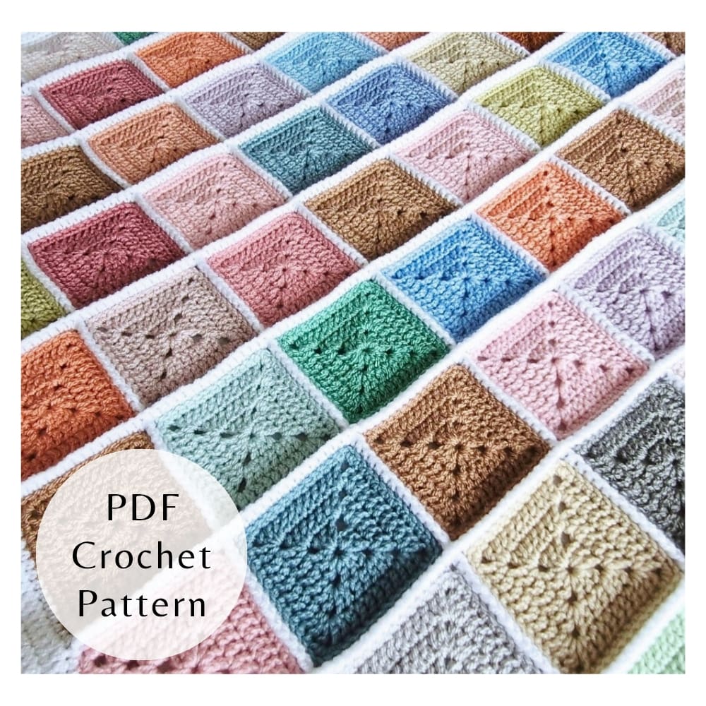 Handmade crochet scrap yarn blanket with white joining and border