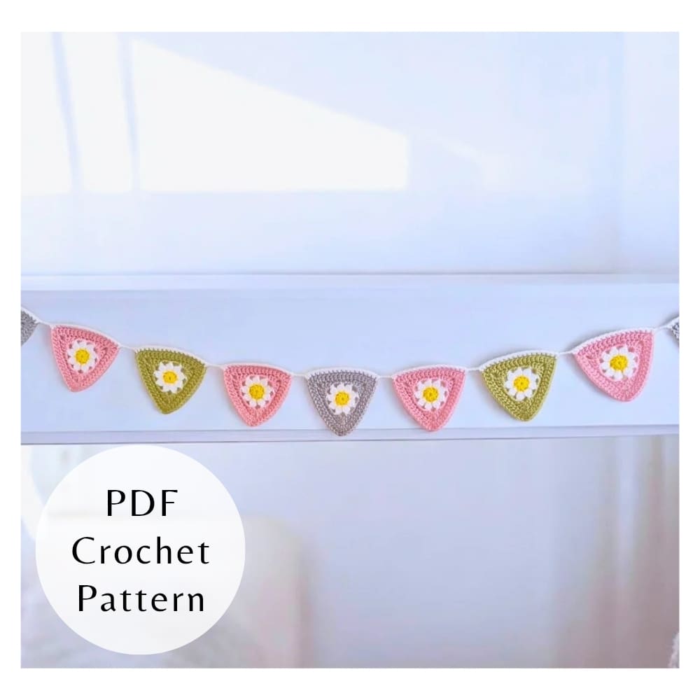 Handmade daisy crochet garland hanging in nursery