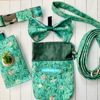 Flat lay of handmade dog-walking gift set in William Morris design. Set includes collar, lead, bow tie, treat pouch and poo bag pouch in duck egg blue.