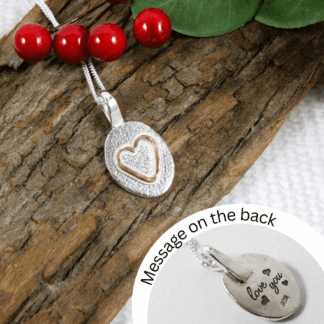 silver pebble with copper heart necklace engraved