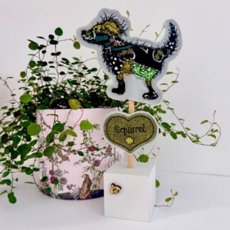 Green patchwork dog standing decoration with squirrel and bee detail