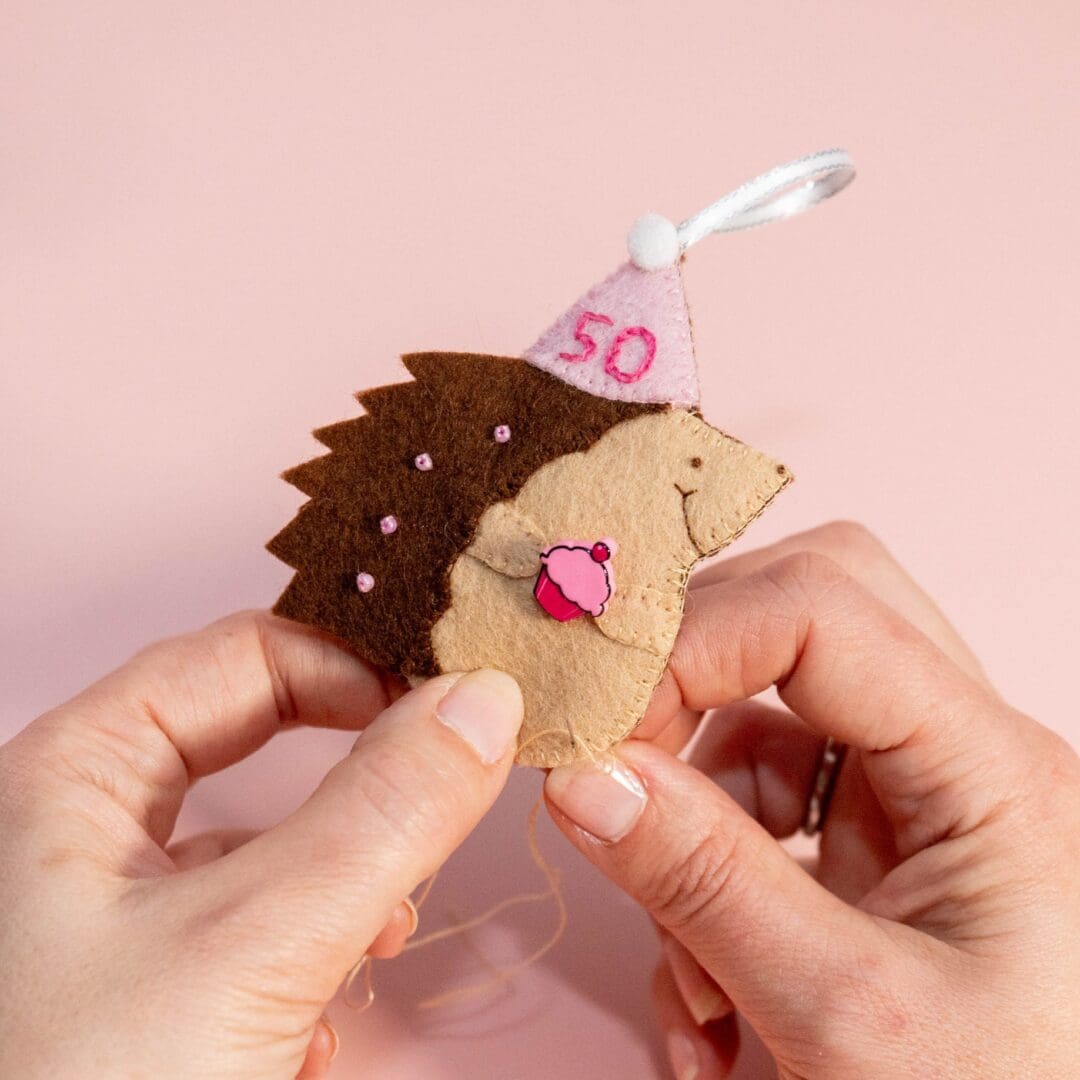 Hand sewing a birthday hedgehog