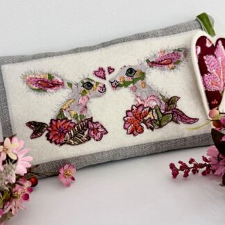 Kissing hares floral cushion with applique detail and additional heart decoration