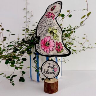 Pretty pink floralfabric hare standing decoration with just bloom imspiational message