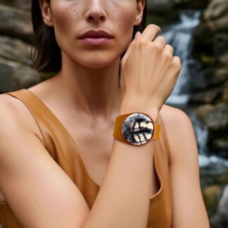 Porcelain Jasper Leather Bracelet on wrist of a lady standing in nature. Made by Freak Like Me in Bristol