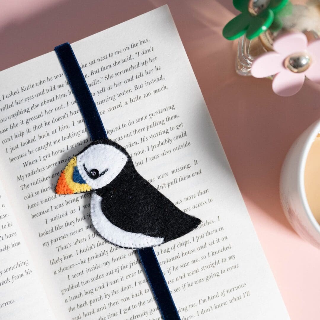 Close up of the puffin bookmark in a book