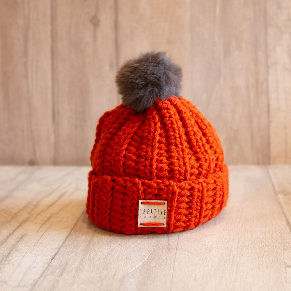 Handmade crochet toddler woolly hat with pom pom. Orange.
