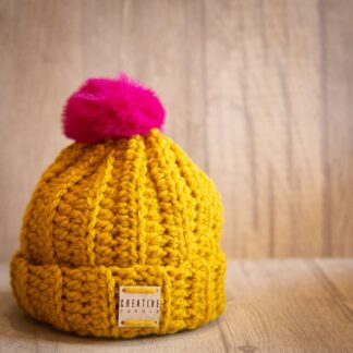 Handmade crochet toddler woolly hat with pom pom. Mustard.