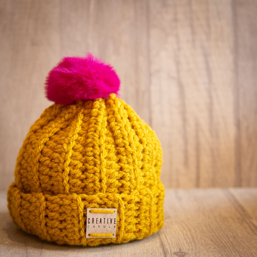 Handmade crochet toddler woolly hat with pom pom. Mustard.