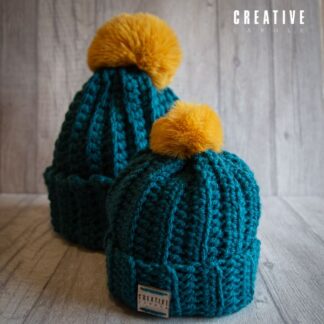 Handmade crochet toddler woolly hat with pom pom. Teal