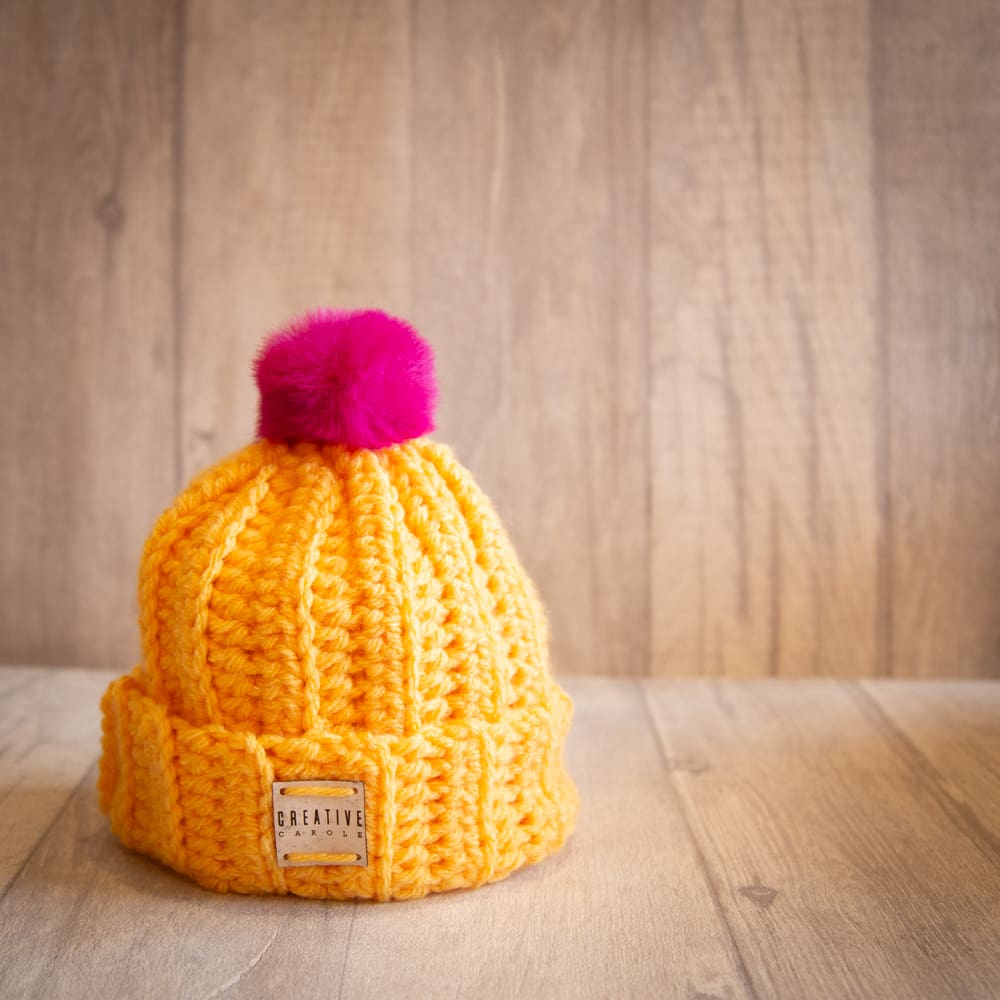 Handmade crochet toddler woolly hat with pom pom. Yellow.