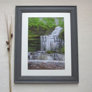 Waterfall tumbling over a limestone cliff into a pool below. Trees overhang and moss grows on the stone.