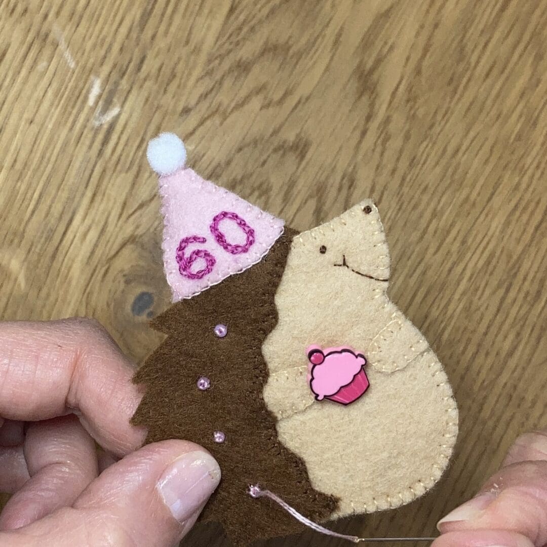 Hand sewing a birthday hedgehog