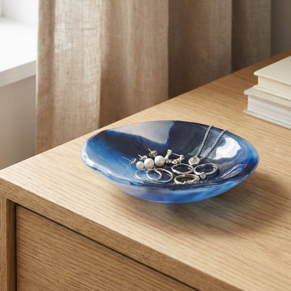 Small handmade blue glass jewellery dish showing marbled blue and white swirls, perfect for rings and earrings