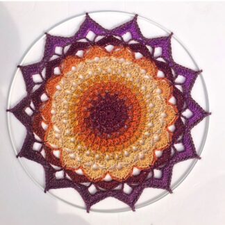 Handmade crochet mandala in glitter gold and purple