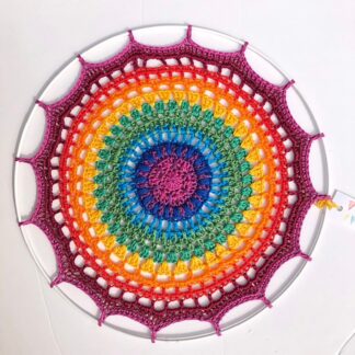 Handmade crochet mandala in a rainbow of love
