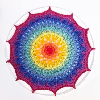 Handmade crochet mandala in a spectrum of rainbow colours