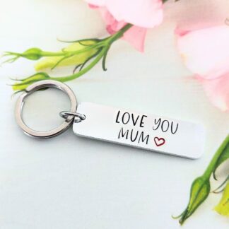 A hand-stamped slim rectangualr keyring with the wording love you mum finished with a heart outline