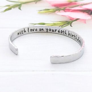 A hand-stamped personalised 6mm width aluminium birthday bracelet for all ages with message hidden inside