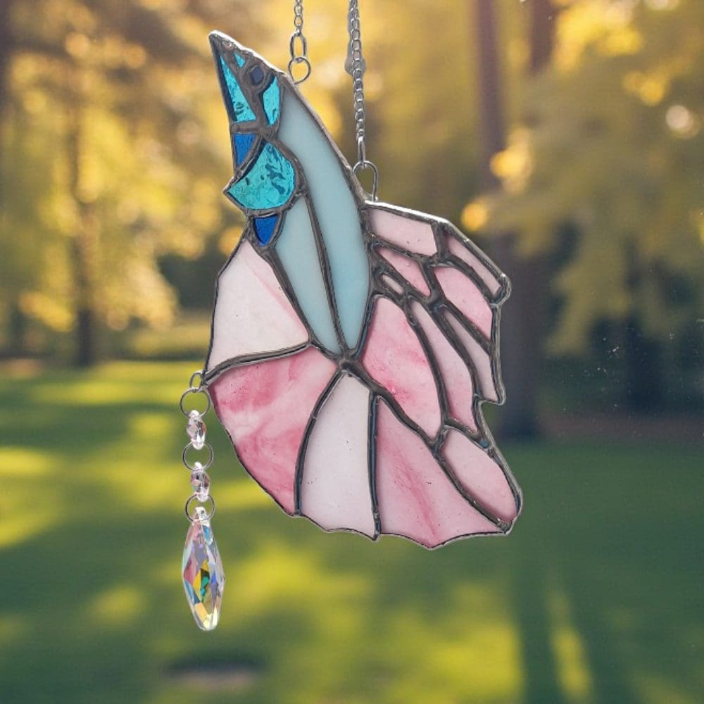 Handmade Tiffany stained glass fish suncatcher in soft pink and turquoise with rainbow-making crystal prism dangling below