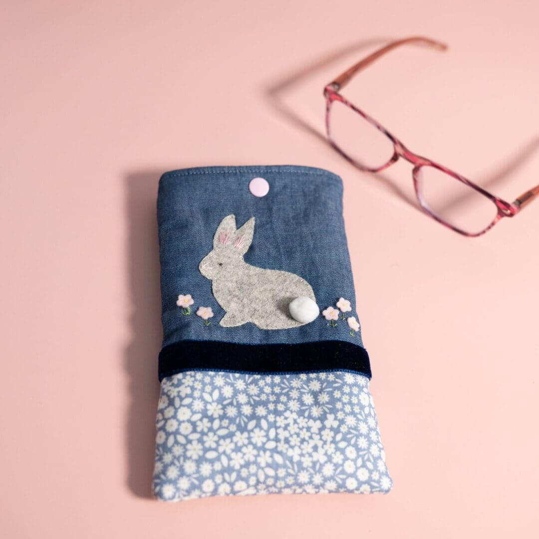 Pretty blue glasses case with a felt bunny on the front