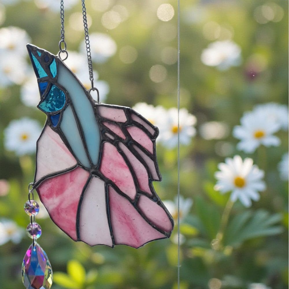 Delicate handmade fish-shaped suncatcher using Tiffany method, featuring pastel pink wings and blue head with black lead lines