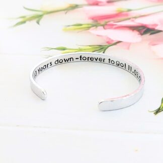 hand-stamped adjustable 6mm aluminium bracelet with a personalised anniversary message hidden inside