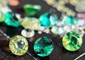 Green gemstones on black background, Isobel Kelly Jewellery