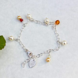 Silver chain bracelet with bead charms and silver leaf charm