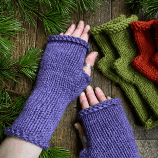Heather purple handknit alpaca armwarmers with a pair of the same in burnt orange and olive green in the background