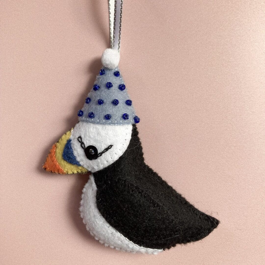 This felt puffin is handmade, has a a ribbon so it can be hung up like a christmas decoration