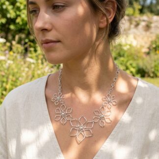 Five flower sterling silver necklace shown on a model's neck