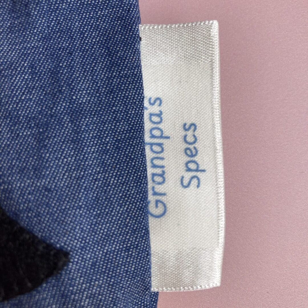 Close up of a personalised seam tag on a puffin glasses case