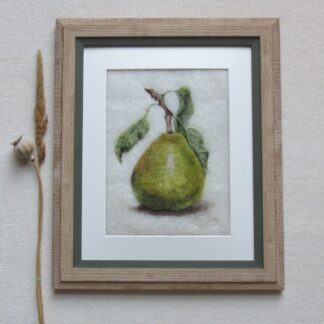 Green pear still life with leaves attached.