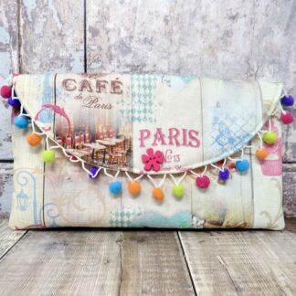 A fun Paris themed clutch with a mini pom pom trim.