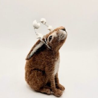 Needle felt brown moon and star gazing hare wearing metal crown which has white clay moon and 3 stars on it dusted with glitter.