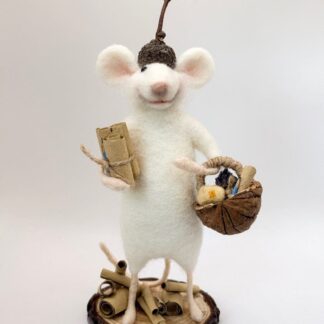 Needle felt white teacher mouse carrying walnut basket with rope handle, containing needle felt cheese, miniature glass bottle decorated with real lavender flowers, miniature wooden pencil. Holding paper scrolls and wearing a real acorn cup hat