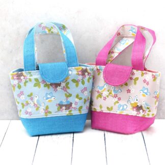 Toy tote handbag in blue or pink print featuring baby birds