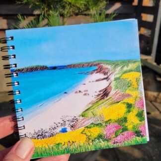 Notebook featuring printed embroidered beach Marloes sands. 12 x 12cm ring bound.