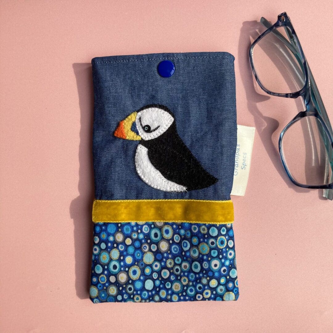 Handmade denim glasses case with a felt puffin hand sewn on to the denim