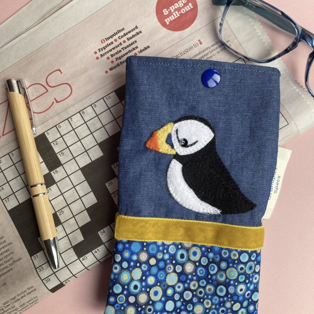 Puffin glasses case on a newpaper crossword