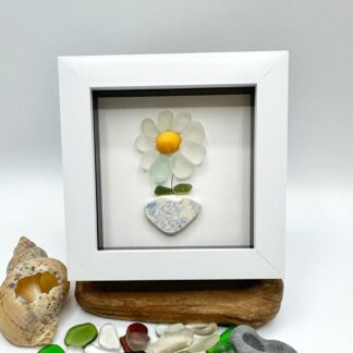 daisy flower with seaglass petals sitting in a sea pottery pot