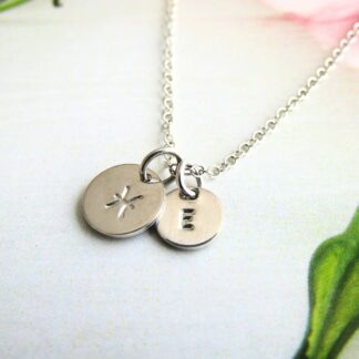 9mm silver disc hand-stamped with a zodiac sign alongside an optional 7mm stamped initial disc, on a silver trace chain necklace