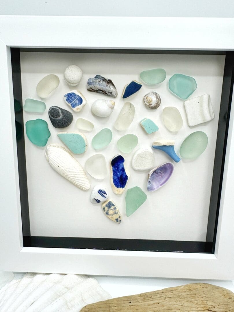 blue and white mosaic heart made from beach finds