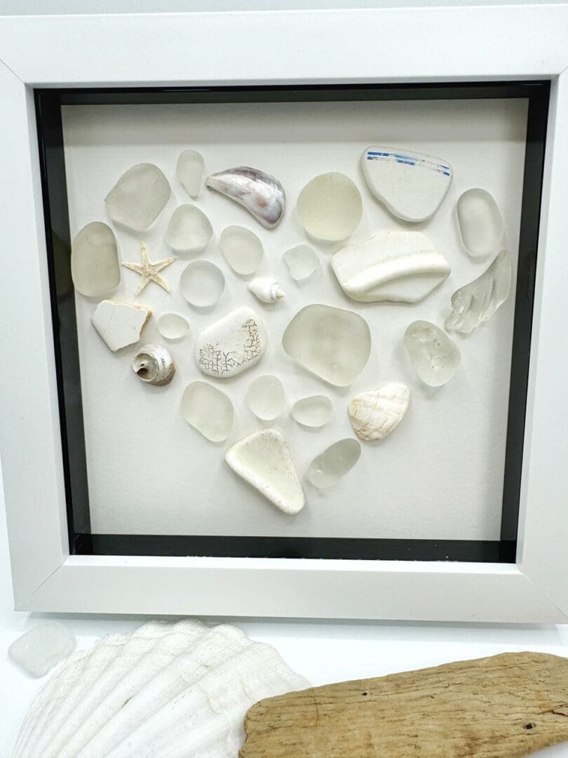 white mosaic heart made from beach finds