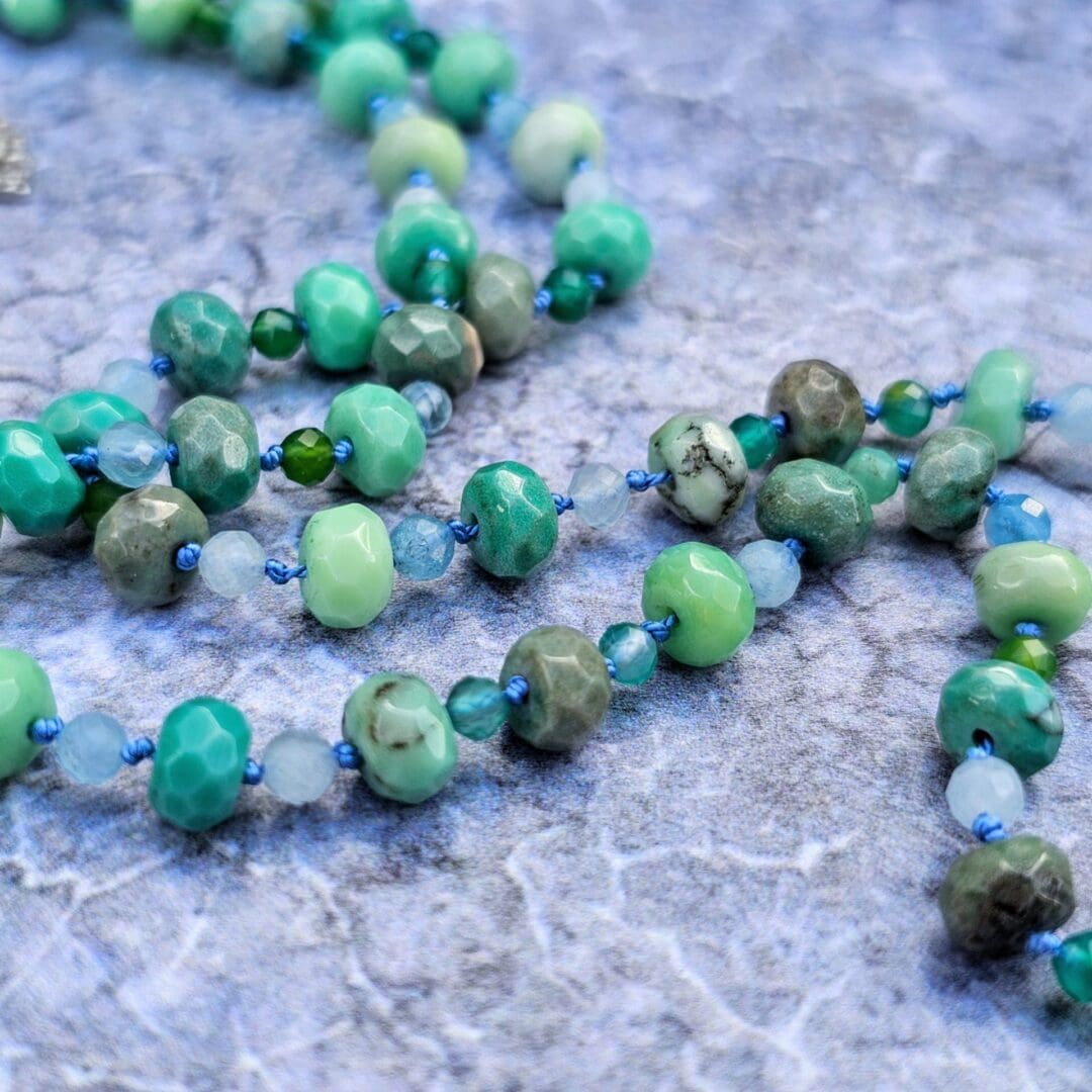Gemstone necklace featuring aquamarine, Peruvian moss opal and green agate beads with a hand pierced silver leaf pendant, Isobel Kelly Jewellery